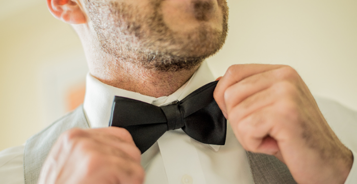 A Men Wearing A Black BowTie