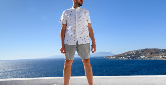 men wearing a white shirt and gray short beside the sea