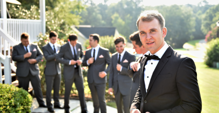 Groom and groomsmen in suit and black tie 