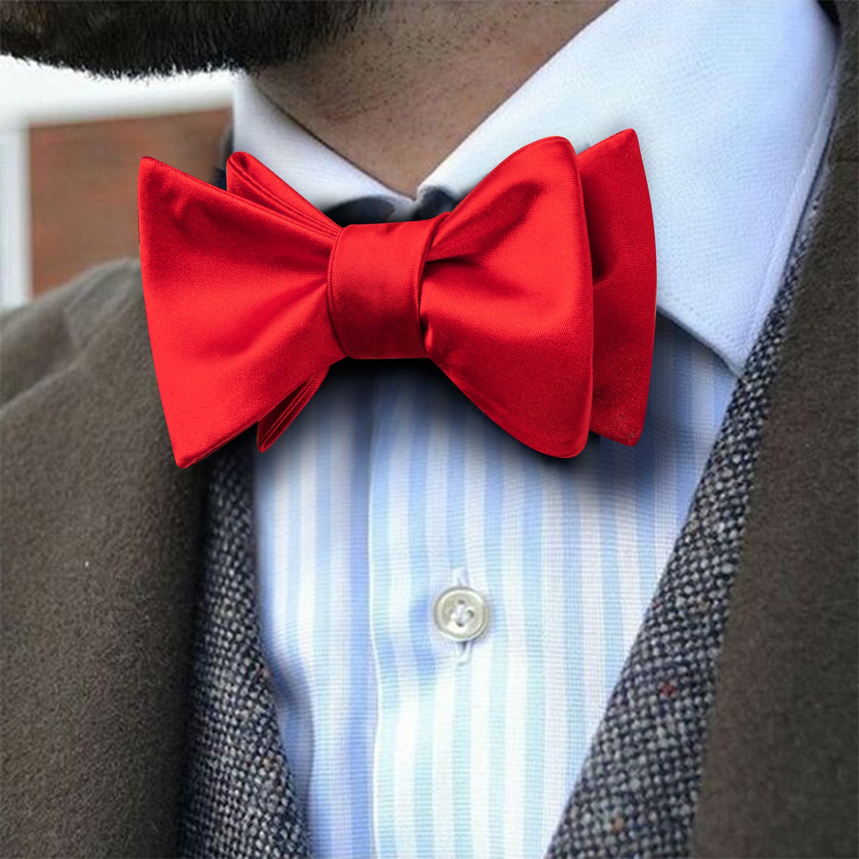 Brown suit jacket with red bow tie 